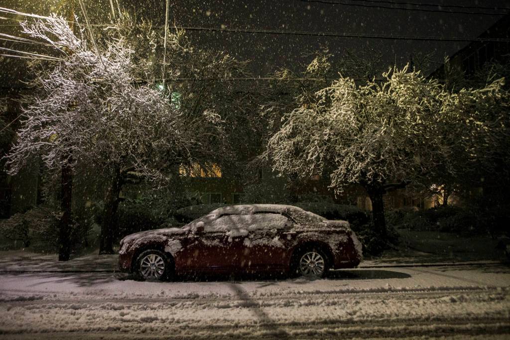 A car sits covered in snow on Sunday, Jan. 12, 2020 in Everett, Wash. (Olivia Vanni / The Herald).