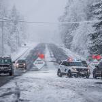 Index residents make their way westbound Monday on the closed U.S. 2, in Gold Bar. The highway was closed at milepost 32 to everyone except Index residents, who were required to have a State Patrol escort to travel east into Index. (Olivia Vanni / The Herald)