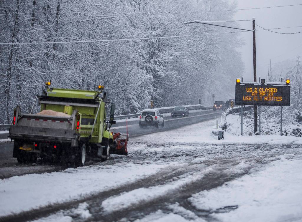 A snow plow waits Monday at the side of U.S. 2 in Monroe. (Olivia Vanni / The Herald)