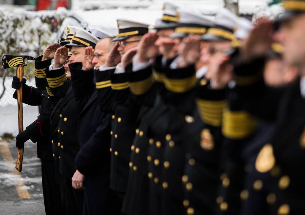 Local fire chiefs and firefighters salute during Gary Meeks retirement ceremony on Wednesday. (Olivia Vanni / The Herald)