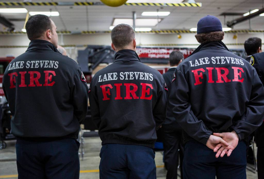 Lake Stevens firefighters stand together on Wednesday. (Olivia Vanni / The Herald)