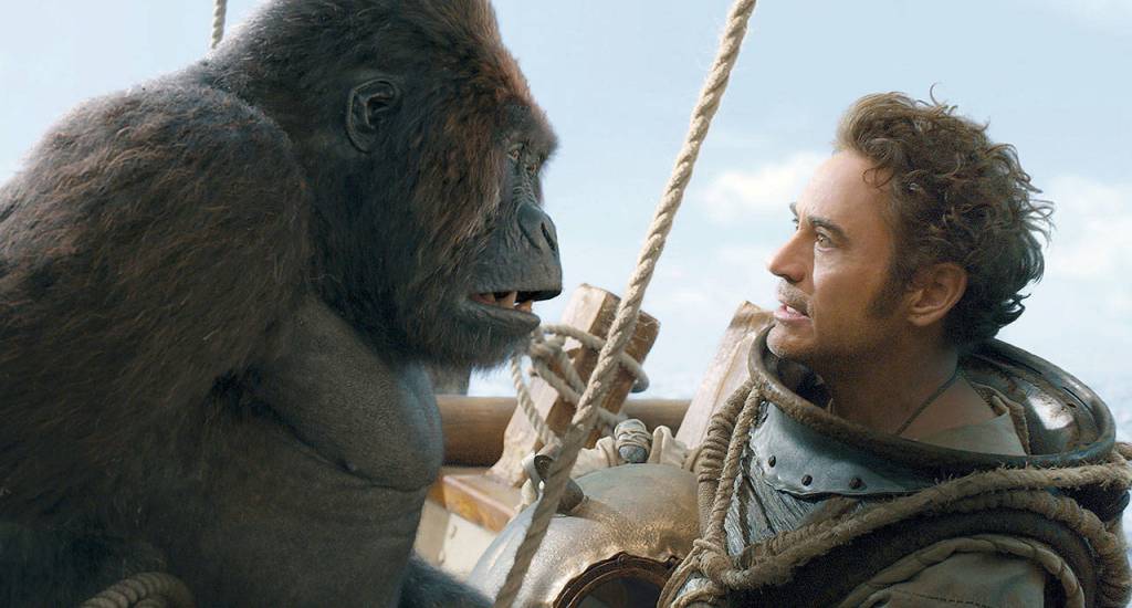 The title character of Dolittle (Robert Downey Jr.) talks to the animals, albeit in a thick, unplaceable accent. (Universal Pictures)                                Chee-Chee, voiced by Rami Malek, left, and Dr. John Dolittle, portrayed by Robert Downey Jr. in a scene from Dolittle. (Universal Pictures)