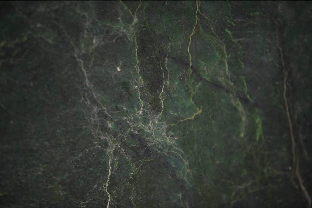 The dark-green jade boulder found by prospectors Ed Moslee and Jason Henry is nephrite jade, commonly used in carvings and furniture such as coffee tables. (Andy Bronson / The Herald)