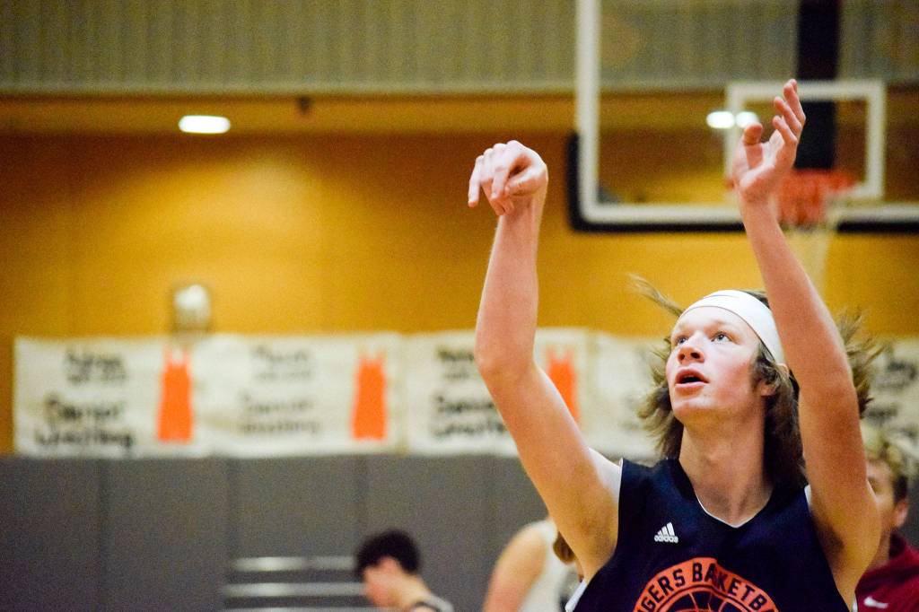 Sam Sylliaasen practices his 3-point shot on Friday, Jan. 17 at Granite Falls High School. (Katie Webber / The Herald)
