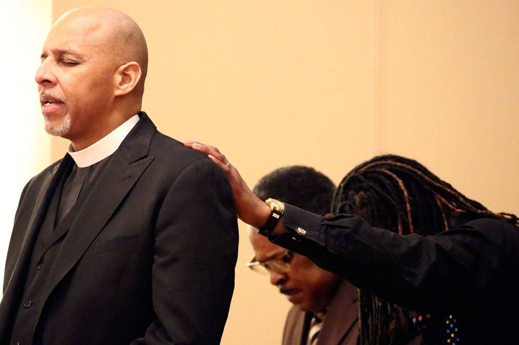 Pastor Alvin Moore delivers the invocation during the Martin Luther King Jr. celebration Sunday afternoon at First Presbyterian Church in Everett. (Kevin Clark / The Herald)