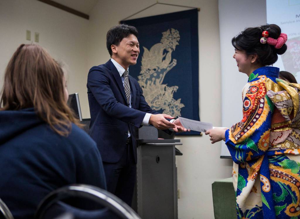 Consul Takayuki Ishikawa of the Consulate-General of Japan in Seattle hands Kotoko Miyamae her certificate on Jan. 24 in Everett. (Olivia Vanni / The Herald)