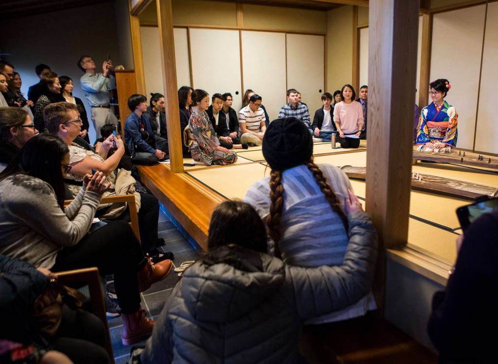 People gather to watch Kotoko Miyamaes Koto performance on Jan. 24 in Everett. (Olivia Vanni / The Herald)