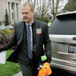 Initiative activist Tim Eyman, who is also running as an independent for Washington governor, carries a clipboard as he walks next to his expired car registration tabs before attending a rally Jan. 13 on the first day of the 2020 session of the Washington Legislature in Olympia. (AP Photo/Ted S. Warren, File)