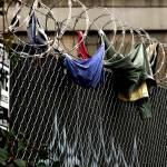 A number of trespassers have given up their shirts and other articles of clothing attempting to climb over razor wire at a fenced location near the Everett Gospel Mission on Smith Avenue in Everett. (Dan Bates / The Herald)