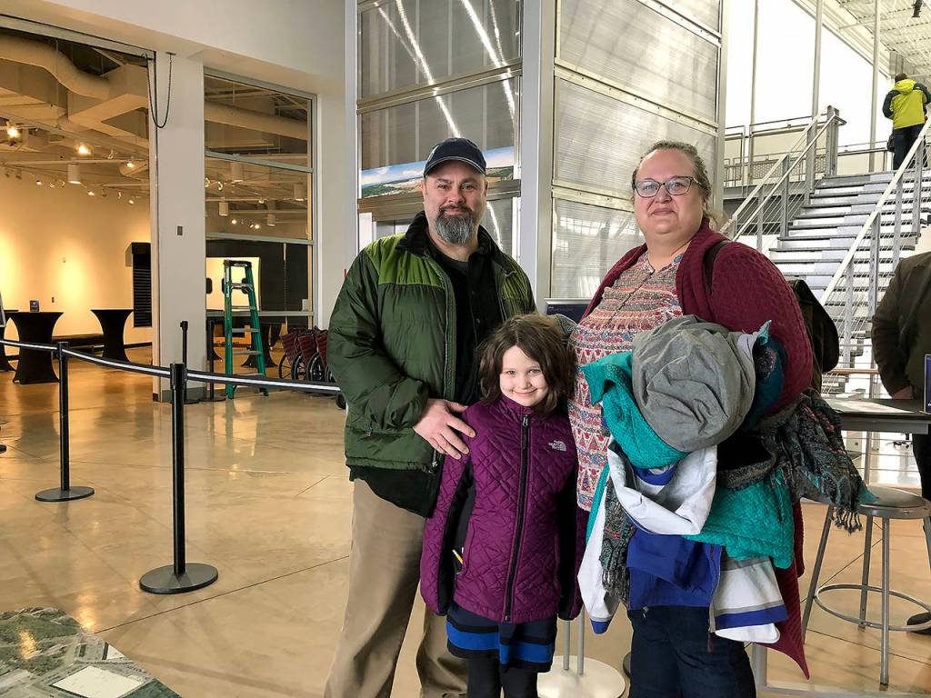 Jon and Sabrina Shaw and their daughter, Emogene, 7, of Snohomish, watched the takeoff from the Future of Flights outdoor observation deck. Jon Shaw is a Boeing engineer who worked on the 777X folding wingtips. (Janice Podsada / The Herald)