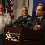 Dr. Chris Spitters (right), interim health officer for the Snohomish Health District, fields questions during a news conference Tuesday afternoon at the state Public Health Laboratories in Shoreline. (Kevin Clark / The Herald)