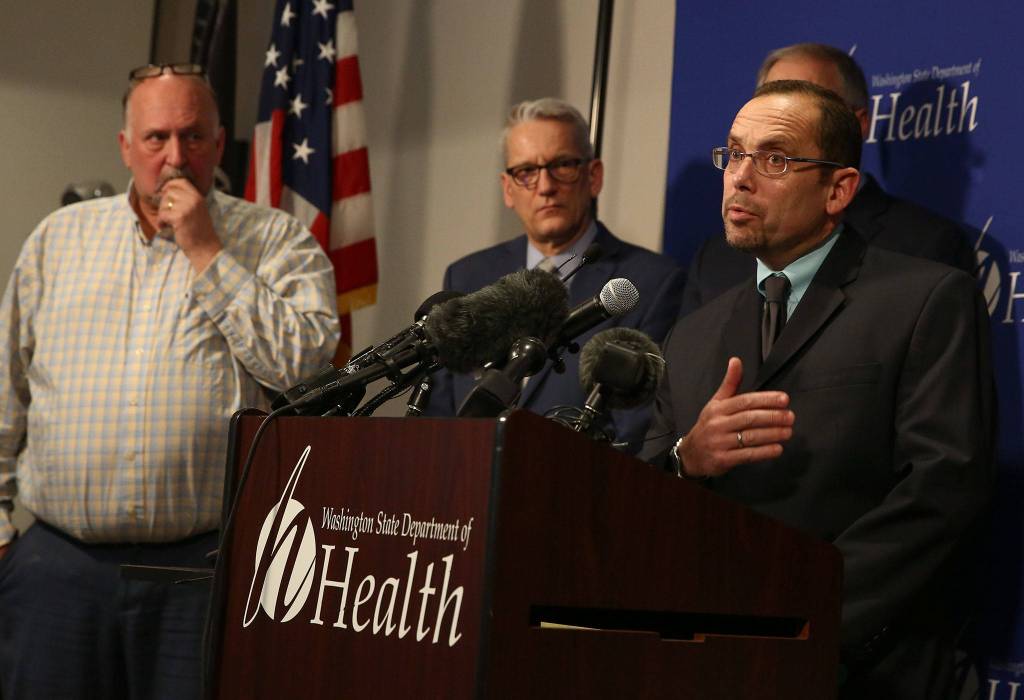 Dr. Chris Spitters (right), interim health officer for the Snohomish Health District, fields questions during a news conference Tuesday afternoon at the state Public Health Laboratories in Shoreline. (Kevin Clark / The Herald)