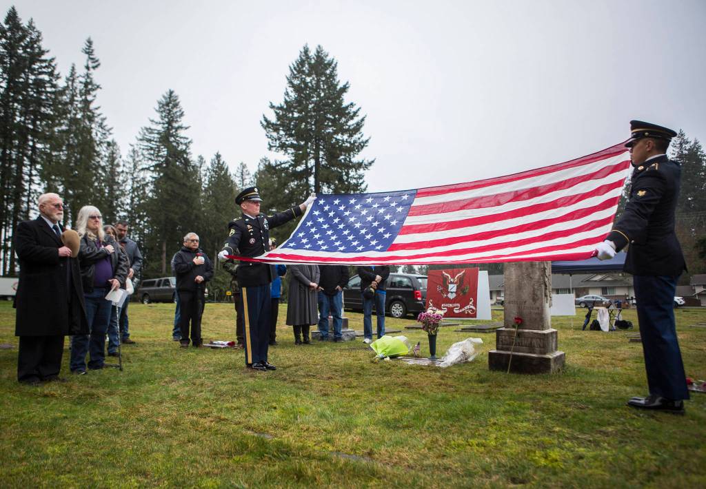 Honor guard members hold a flag during the ceremony for Joseph Harriman on Saturday, Jan. 25, 2020 in Monroe, Wash. After 70 years, the World War II veteran now has a grave marker, one that recognizes his military service.(Olivia Vanni / The Herald)