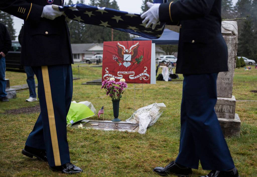 An honor guard folds up the flag before giving it to Pat Fitchen in honor of Joseph Harriman on Saturday, Jan. 25, 2020 in Monroe, Wash. After 70 years, the World War II veteran now has a grave marker, one that recognizes his military service. (Olivia Vanni / The Herald)