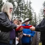 Pat Fitchen, left, receives an eagle feather for Snoqualmie Tribe chairman Bob De Los Angles to honor Joseph Harrimans strength and bravery on Saturday, Jan. 25, 2020 in Monroe, Wash. After 70 years, the World War II veteran now has a grave marker, one that recognizes his military service. (Olivia Vanni / The Herald)