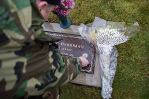 Snoqualmie Tribe treasurer Chris Castleberry places a Native Veteran medallion on Joseph Harrimans headstone on Saturday, Jan. 25, 2020 in Monroe, Wash. The World War II veteran died in 1950. His grave site went unmarked for 70 years.(Olivia Vanni / The Herald)