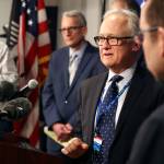 Dr. Jay Cook (second from right), chief of surgery at Providence Regional Medical Center Everett, fields questions during a news conference Tuesday at the state Public Health Laboratories in Shoreline. (Kevin Clark / The Herald)