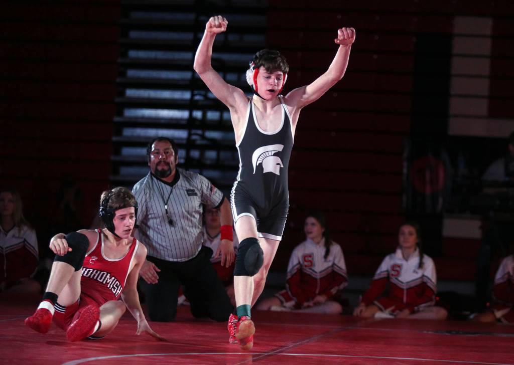 Stanwood&rsquo;s Bryan Roodzant raises his arms in victory after pinning Snohomish&rsquo;s Colby Skowron as Snohomish lost to Stanwood 41-39 in a boys&rsquo; wrestling meet on Tuesday, Jan. 28, 2020 in Snohomish, Wash. (Andy Bronson / The Herald)
