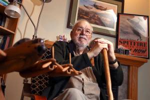 Mike Mancer, 80, of Stanwood, has a portion of his living room dedicated to his fathers service in the British Royal Air Force during World War II. (Kevin Clark / The Herald)