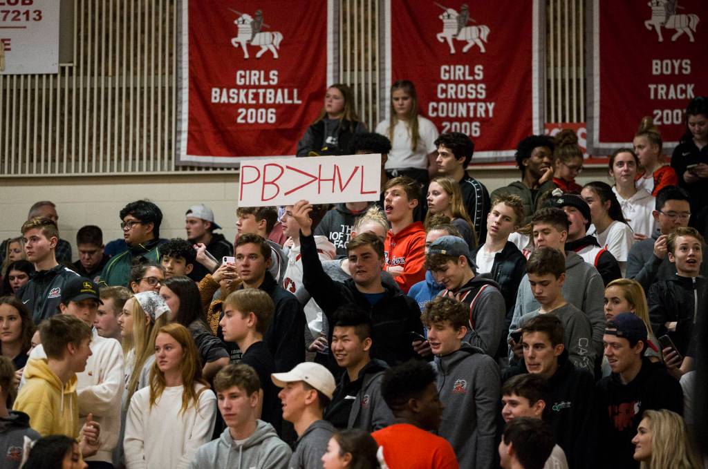 The Kings student section holds up a sign that means Paige Bueckers is better than Hailey Van Lith, both are top-10 recruits in the nation, during against Kings on Saturday in Shoreline. Van Lith plays for Cashmere and Bueckers plays for Hopkins High School in MInnetonka, Minn. (Olivia Vanni / The Herald)