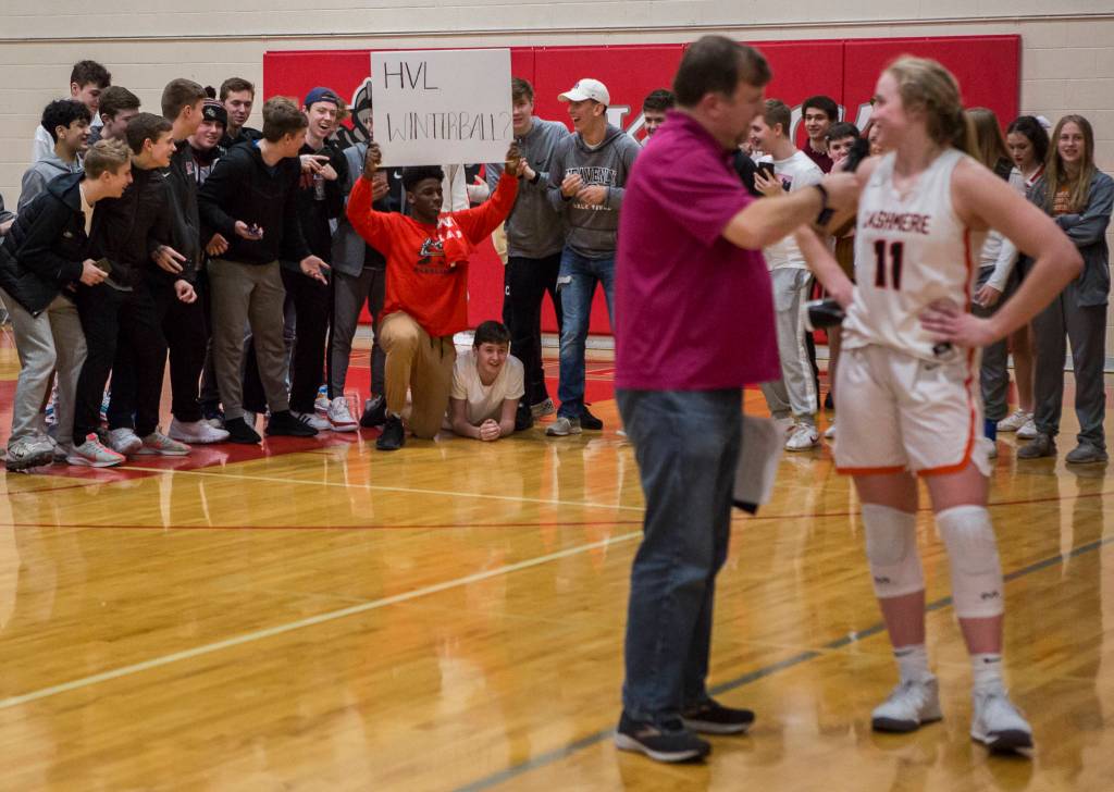 Cashmeres Hailey Van Lith smiles as she looks back and sees a Kings student with a sign asking her to their Winterball dance after a game on Saturday in Shoreline. (Olivia Vanni / The Herald)
