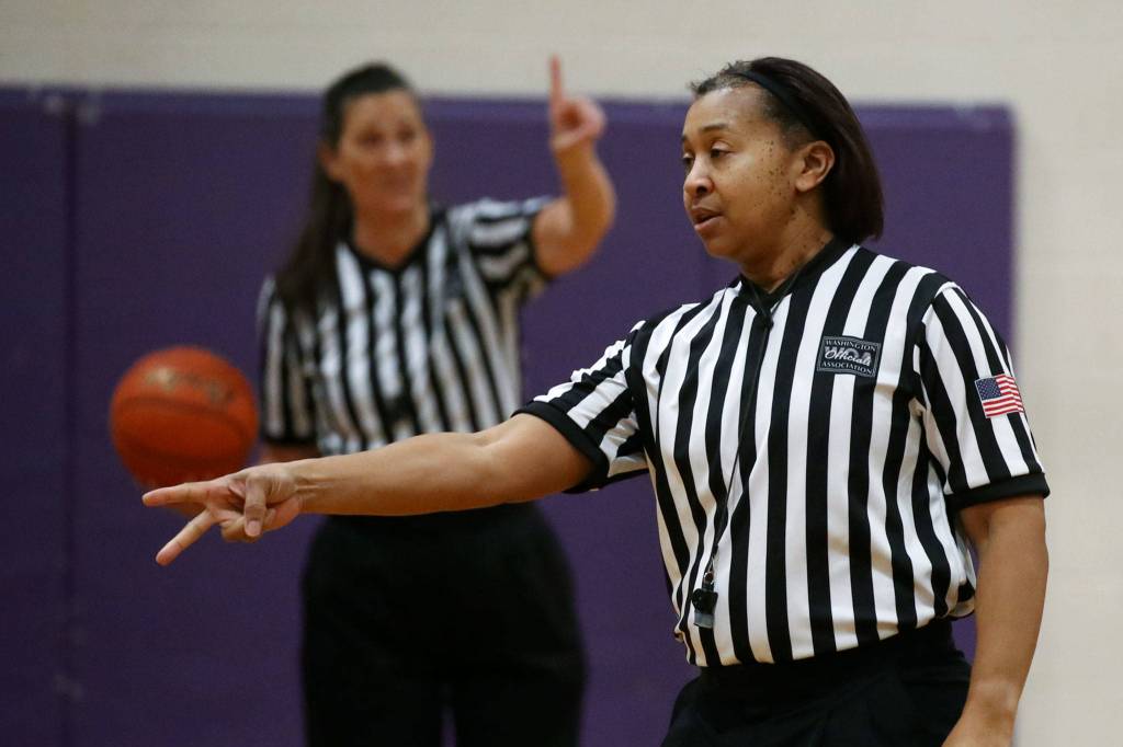 Lezley Smith (front) and Judy Dybing (rear) officiate a girls basketball game between Mountlake Terrace and Edmonds-Woodway on Tuesday evening at Edmonds-Woodway High School. (Kevin Clark / The Herald)