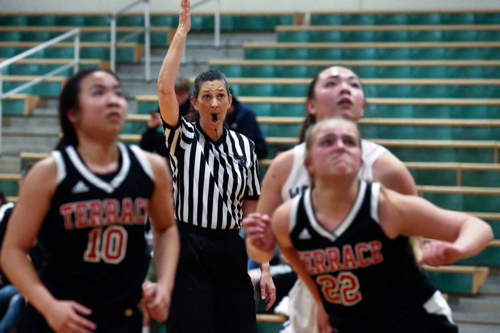 Official Judy Dybing watches the action on the court Tuesday evening at Edmonds-Woodway High School. (Kevin Clark / The Herald)