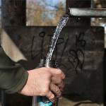 A man fills a water bottle at an artesian well in Lynnwood. (Andy Bronson / Herald file)