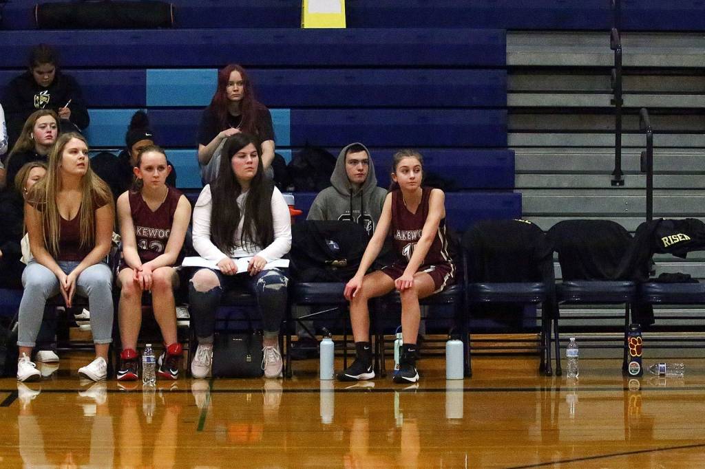 Players on the Lakewood bench watch the action on the floor during a junior varsity game Thursday evening at Sultan High School. (Kevin Clark / The Herald)
