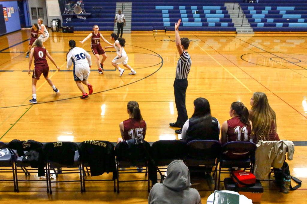 Players on the Lakewood bench watch the action on the floor during a junior varsity game on Thursday evening at Sultan High School. (Kevin Clark / The Herald)