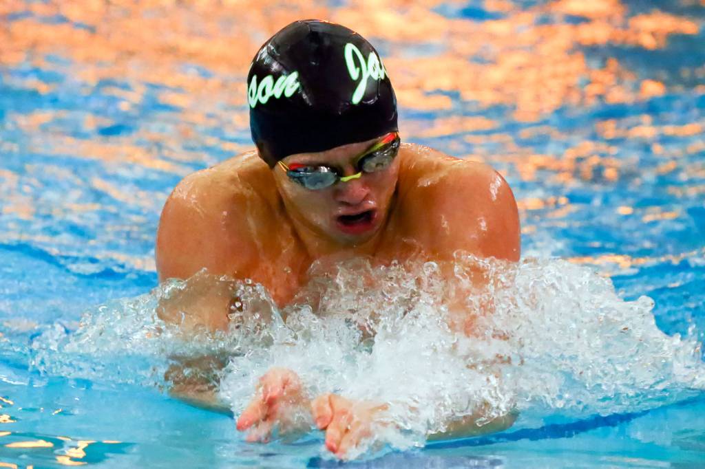 Jackson senior standout Justin Limberg swims a season-best time in the 200-yard individual medley, which was one of two individual races he won. (Kevin Clark / The Herald)