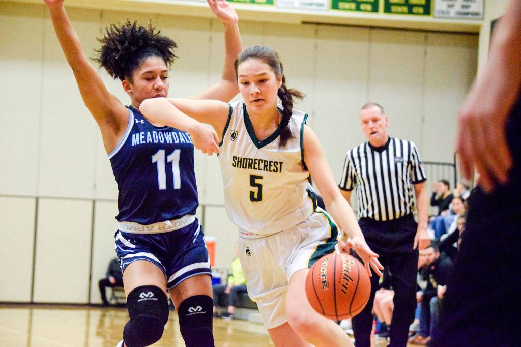 Shorecrests Amanda Lee dribbles past Meadowdales Kaisha Stark on Thursday, Jan. 30 at Shorecrest High School in Shoreline. (Katie Webber / The Herald)
