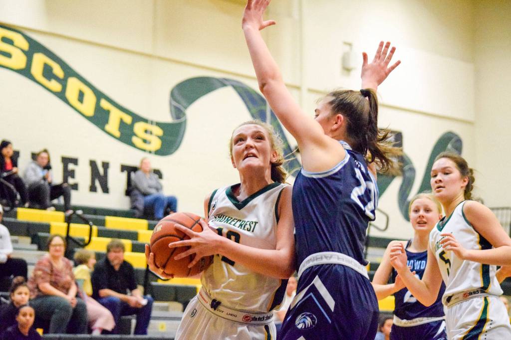 Shorecrests Taylor Svendsen attempts to layup a basket against Meadowdales Ava Powell (right) on Thursday, Jan. 30 at Shorecrest High School in Shoreline. (Katie Webber / The Herald)