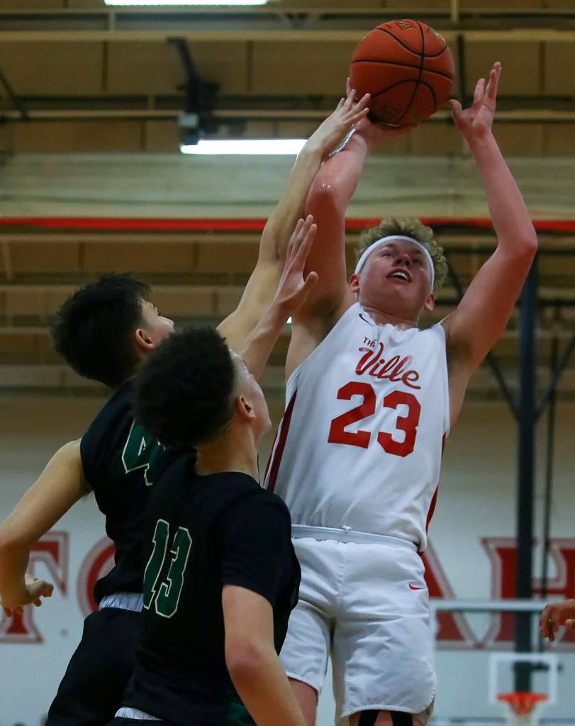 Marysville-Pilchucks Cameron Stordahl attempts a shot over Marysville-Getchells Landyn Olson and Austin Townsend Friday evening at Marysville-Pilchuck High School in Marysville on January 31, 2020. The Tomahawks won 61-57. (Kevin Clark / The Herald)