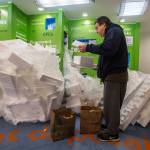 Matthew Ortiz recycles some of his styrofoam at the Recology store in Bothell. (Olivia Vanni / The Herald)