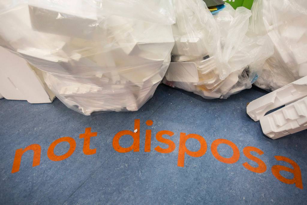 Not disposable is printed on the floor next to the styrofoam recycling area at Recology in Bothell. (Olivia Vanni / The Herald)