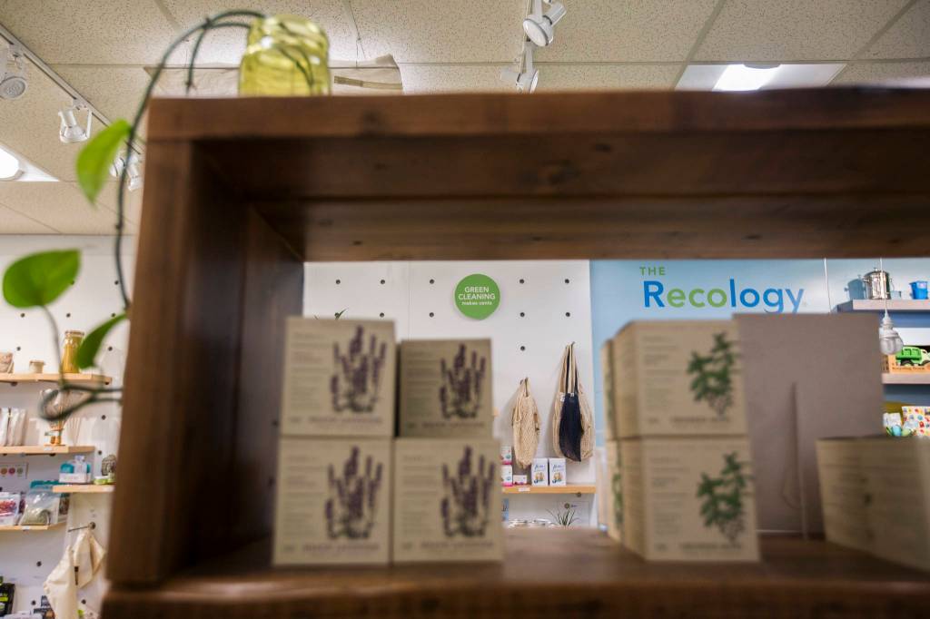 Environmentally friendly products and mottos line the shelves and walls of the Recology store in Bothell. (Olivia Vanni / The Herald)