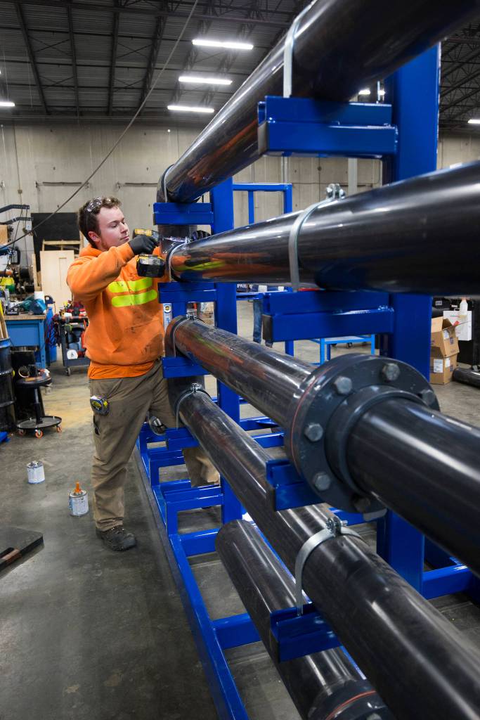 Austin Kostenko, a hydraulic fabricator, at work at WaterTectonics in Everett.