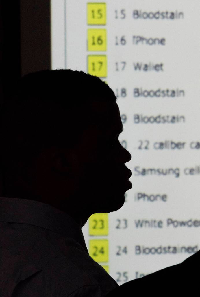 A list corresponding to evidence markers is show on a screen during the opening day trial of Edmond Overton at the Snohomish County Courthouse on Wednesday in Everett. (Andy Bronson / The Herald)