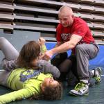 Darrington coach Ray Franke instructs Amanda Brown (top) and Laura Langer during practice Feb. 6 at Darrington High School. (Kevin Clark / The Herald)