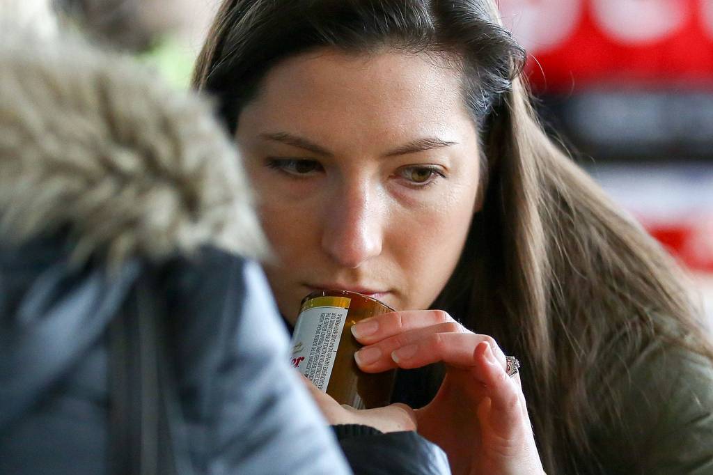 Heather Newman smells candles Sunday morning at the Popup Market at Village Theatre in Everett on February 9, 2020. (Kevin Clark / The Herald)