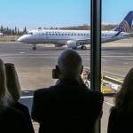 The first United Airlines flight serving Paine Field in Everett taxis to the gate last March 31. (Kevin Clark / The Herald)
