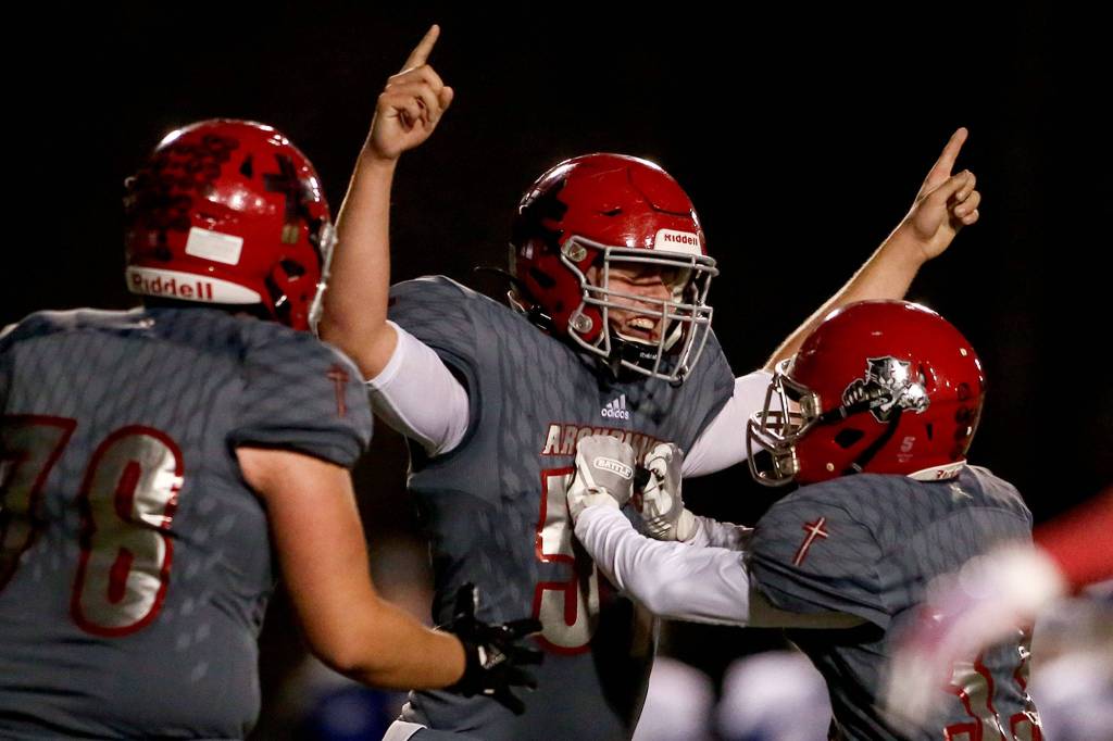 Archbishop Murphy senior Tommy Sullivan (center) celebrates after recovering a fumble during the Wildcats 23-6 victory over Sedro-Woolley on Nov. 8, 2019, at Archbishop Murphy High School in Everett. (Kevin Clark / The Herald)