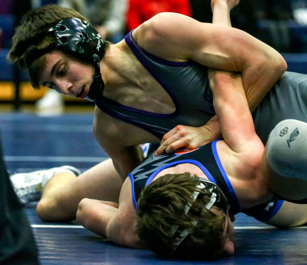Lake Stevens Tyler Fouts works against Graham-Kapowsins Kai Calhoun in the 120-pound final at the 4A Region 1 Tournament Saturday afternoon at Glacier Peak High School in Snohomish. Fouts won by major decision to help lead Lake Stevens to the regional team championship. (Kevin Clark / The Herald)