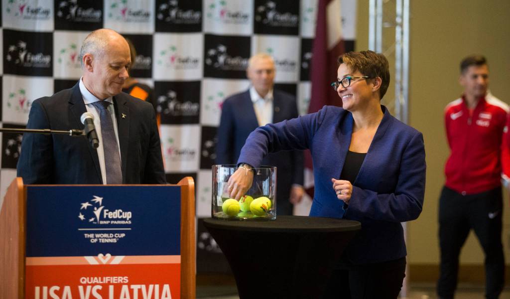 ITF referee Wayne McKewen watches as Everett Mayor Cassie Franklin draws a name to set the weekends order of play for the Fed Cup event at Angel of the Winds Arena on Thursday in Everett. (Andy Bronson / The Herald)