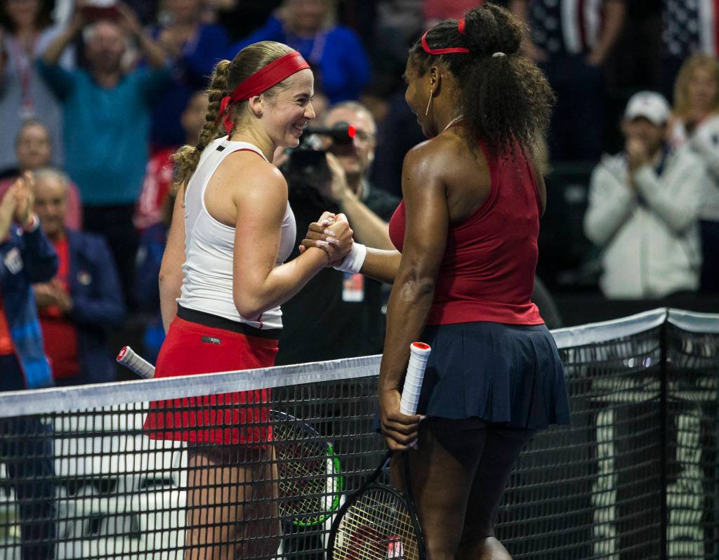 Jelena Ostapenko smiles while shaking Serena Williams hand after their match at the Fed Cup at Angel of the Winds Arena on Friday in Everett. (Olivia Vanni / The Herald)