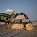 In this Dec. 22, 2019 photo, Boeing, NASA and U.S. Army personnel work around the Boeing Starliner spacecraft shortly after it landed in White Sands, New Mexico. (Bill Ingalls/NASA via AP)