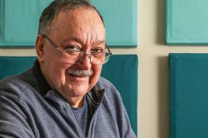 Marysvilles Phil Jubie holds a book of poetry by John Greenleaf Whittier that once belonged to his great-uncle, Edwin Ritchie. Jubie would love to know the story behind the books inscription, from someone named Lulu. (Dan Bates / The Herald)