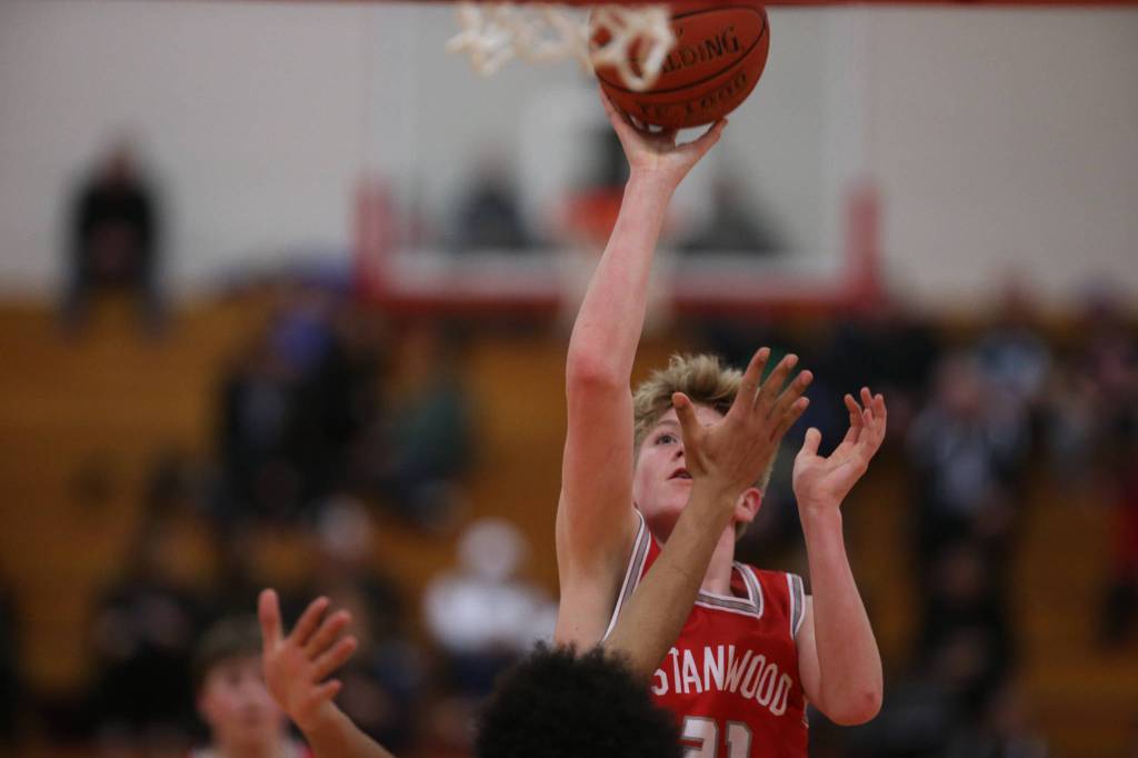 Stanwoods Dom Angelshaug takes a shot as Marysville Pilchuck beat Stanwood 76-31 in a basketball game Monday, Feb. 10, 2020 in Marysville. (Andy Bronson / The Herald)