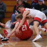 Marysville Pilchucks Aaron Kalab leaps over Stanwoods Dom Angelshaug for the ball as they scramble on the floor. Marysville Pilchuck beat Stanwood 76-31 in a basketball game Monday, Feb. 10, 2020 in Marysville. (Andy Bronson / The Herald)